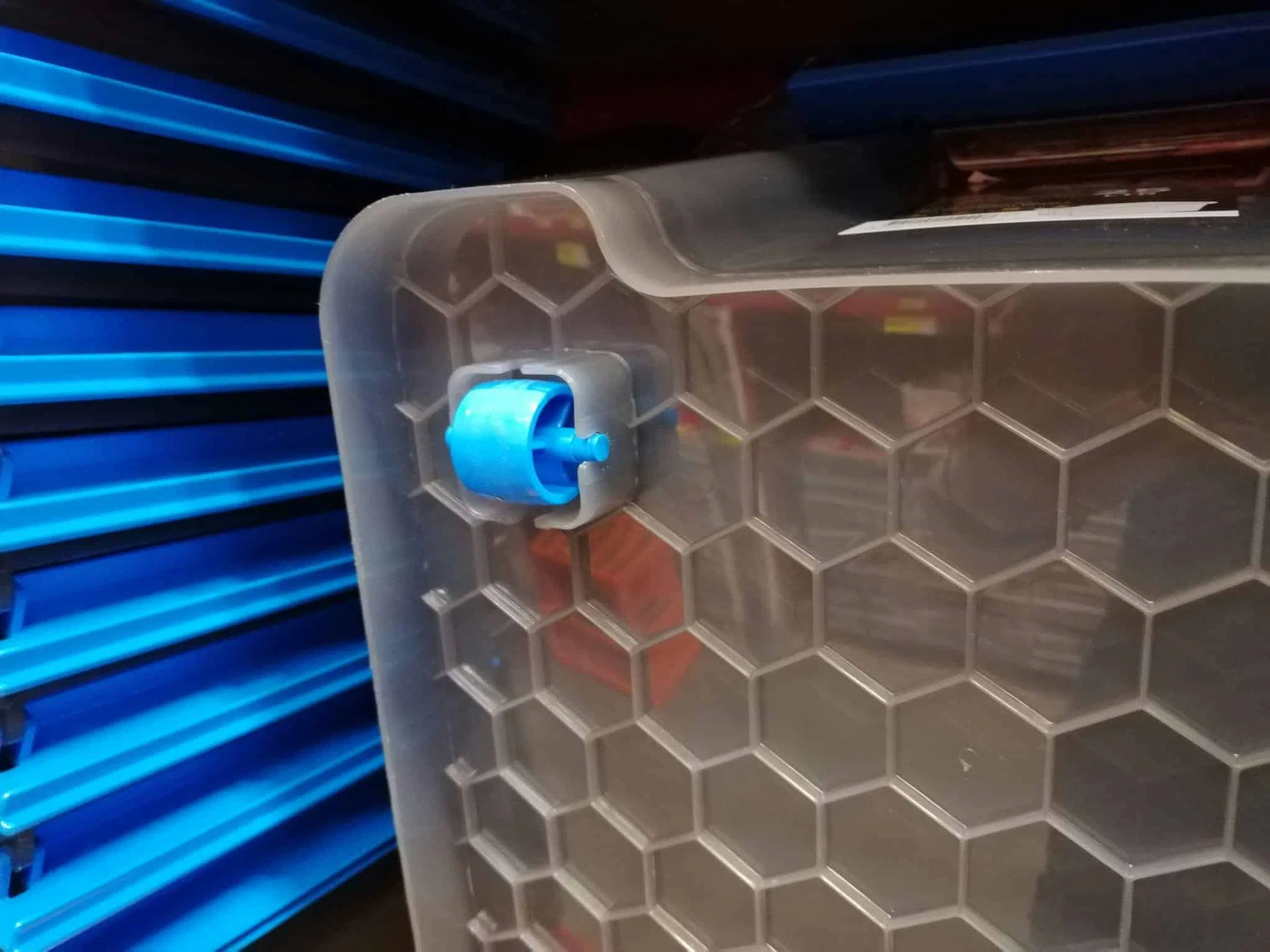 Plastic wheels on the bottom of a plastic storage box which can sometimes break or come off