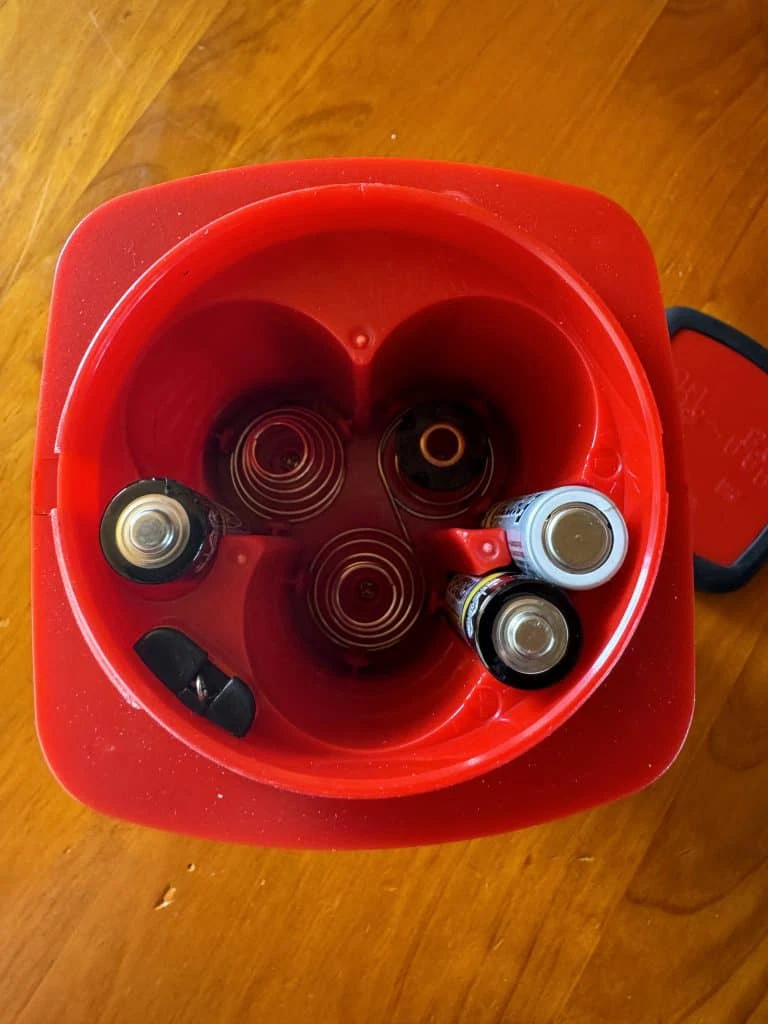 The bottom of the lantern with the battery compartment open.