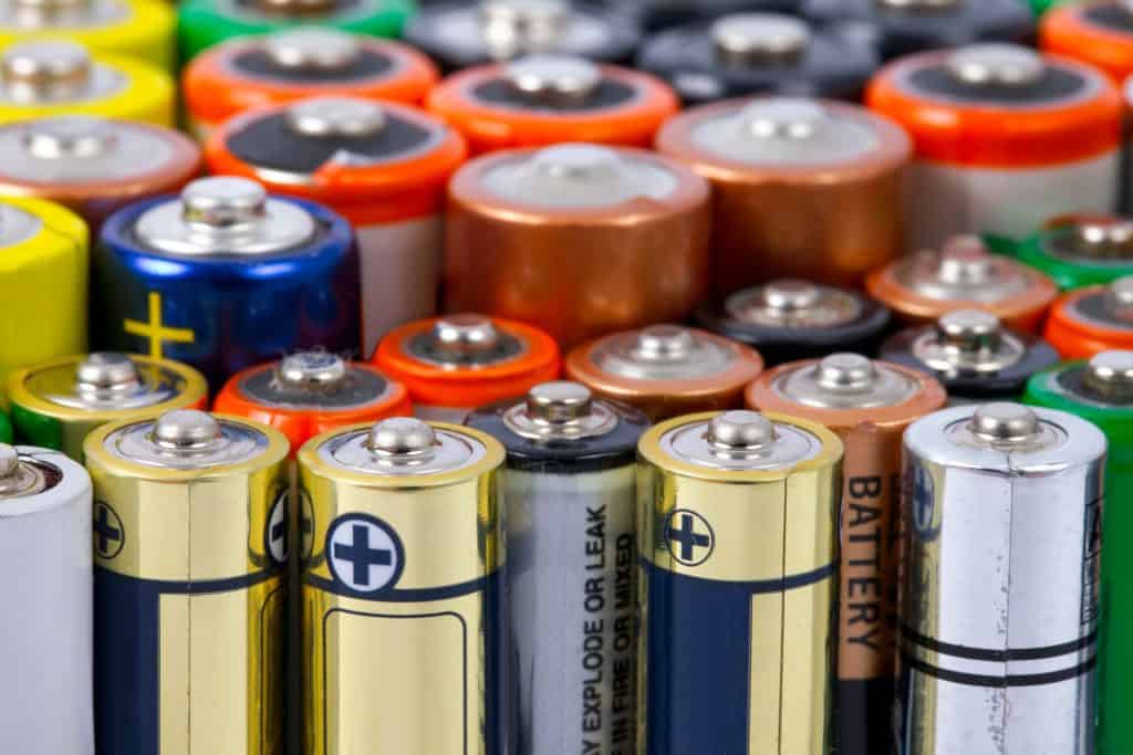 Many different types of batteries are arranged in a row.